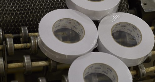 rolls of tape on an assembly line